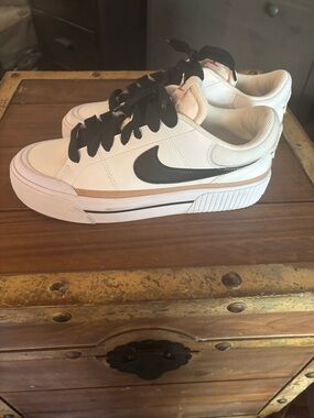 Nike White Sneakers with Black Swoosh and Tan Accent